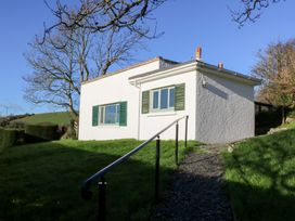 A house with green shutters and a pathway in Bryncyn, Newport, Pembrokeshire