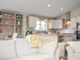 A kitchen with dining table and sofa at 2 Summerleaze Bude