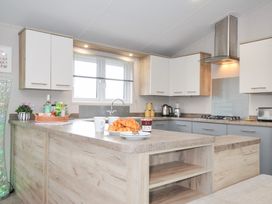 A kitchen with an island and window at 2 Summerleaze in Bude
