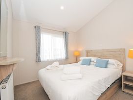 A bedroom with a bed and bedside table at 2 Summerleaze in Bude