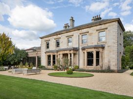 A house with a garden and gravel path at The Country House Cumbria Castle Carrock