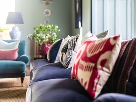 A living room with cushions on a sofa at The Country House Cumbria Castle Carrock