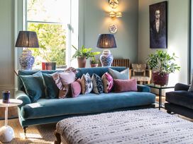 A living room with a sofa and lamps at The Country House Cumbria Castle Carrock