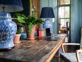 A table with a computer and plants at The Country House Cumbria in Castle Carrock