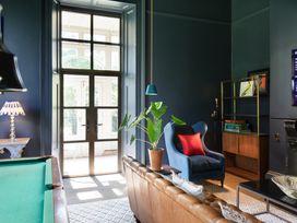 A living room with a pool table and plant at The Country House Cumbria Castle Carrock