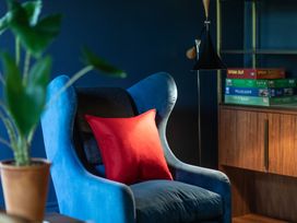 A living room with an armchair and a plant at The Country House Cumbria Castle Carrock