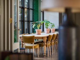 A dining room with a wooden table and chairs at The Country House Cumbria Castle Carrock