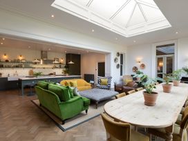 A living room with a sofa and dining table at The Country House Cumbria Castle Carrock