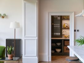 A kitchen with shelves and a doorway at The Country House Cumbria in Castle Carrock