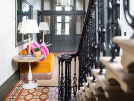 A hallway with a sofa and a mirror at The Country House Cumbria, Castle Carrock