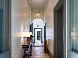 A hallway with a table and lamp at The Country House Cumbria in Castle Carrock