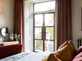 A bedroom with a bed and window at The Country House Cumbria in Castle Carrock