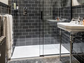 A bathroom with a shower and sink at The Country House Cumbria located in Castle Carrock
