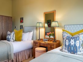 A bedroom with two beds and nightstands at The Country House Cumbria Castle Carrock