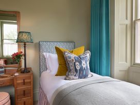 A bedroom with a bed and decorative pillows at The Country House Cumbria, Castle Carrock