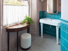 A bathroom with a sink and a mirror at The Country House Cumbria Castle Carrock
