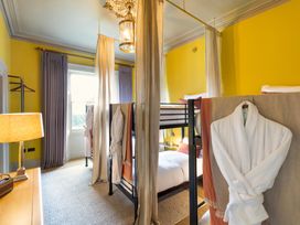 A bedroom with bunk beds and a table lamp at The Country House Cumbria in Castle Carrock