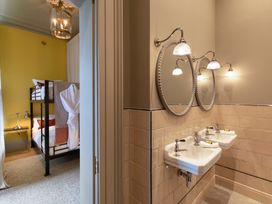 A bathroom with dual sinks and mirrors at The Country House Cumbria in Castle Carrock