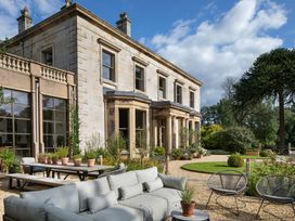 An outdoor area with furniture and plants at The Country House Cumbria Castle Carrock