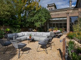 An outdoor seating area with a couch and chairs at The Country House Cumbria Castle Carrock