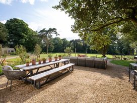A garden area with a table and chairs at The Country House Cumbria in Castle Carrock