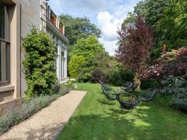 A garden area with chairs and plants at The Country House Cumbria Castle Carrock