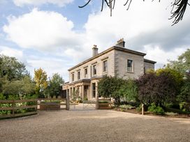 A house with a gravel driveway at The Country House Cumbria Castle Carrock