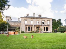 A house with chickens in the garden at The Country House Cumbria in Castle Carrock