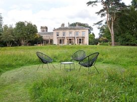Chairs and a table in a garden at The Country House Cumbria, Castle Carrock