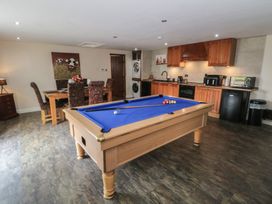 A games room with a pool table and kitchen amenities at Pompian Lodge in Leyland