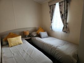 A bedroom with two beds and a window at 123 Elms
