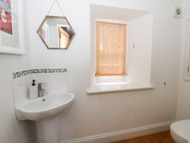 A bathroom with a sink and mirror at Secret Garden Cottage in Ciliau Aeron near Aberaeron