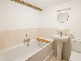 A bathroom with a bathtub, sink, and toilet at Secret Garden Cottage in Ciliau Aeron near Aberaeron