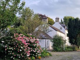 A house surrounded by gardens and flowers at Secret Garden Cottage in Ciliau Aeron near Aberaeron