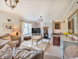 A living room with a sofa and a fireplace at The Old Farm House near Pelynt