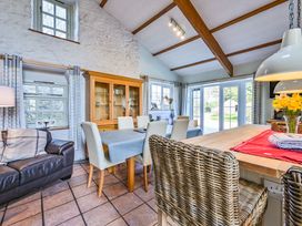 A dining room with a table and chairs at The Old Farm House near Pelynt
