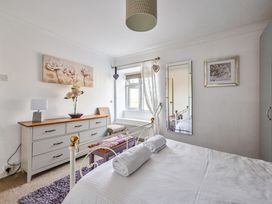 A bedroom with a bed and dresser at The Old Farm House near Pelynt