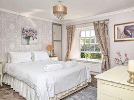 A bedroom with a bed and decorative items at The Old Farm House near Pelynt