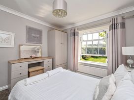 A bedroom with a bed and dressing table at The Old Farm House near Pelynt