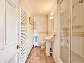 A bathroom with shower and sink at The Old Farm House near Pelynt