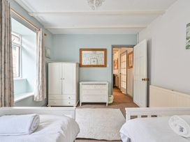 A bedroom with a bed and wardrobe at The Old Farm House near Pelynt