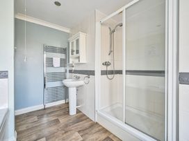A bathroom with a shower and sink at The Old Farm House near Pelynt