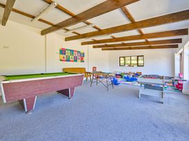 A games room with a pool table and foosball table at The Old Farm House near Pelynt