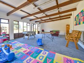 A playroom with a foosball table and a pool table at The Old Farm House near Pelynt