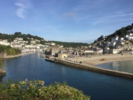 A coastal view with water and houses at The Old Farm House near Pelynt