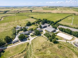 An aerial view of farmland and buildings at The Old Farm House near Pelynt