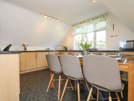 A kitchen with a dining table and chairs at Valley Lodge 61 Callington