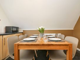 A dining room with a table and chairs at Valley Lodge 61 Callington