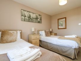 A bedroom with two beds and a nightstand at Valley Lodge 61 Callington