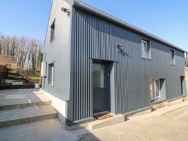 An exterior view of a modern house with a door and windows at The Loft in Glenmore, County Kilkenny